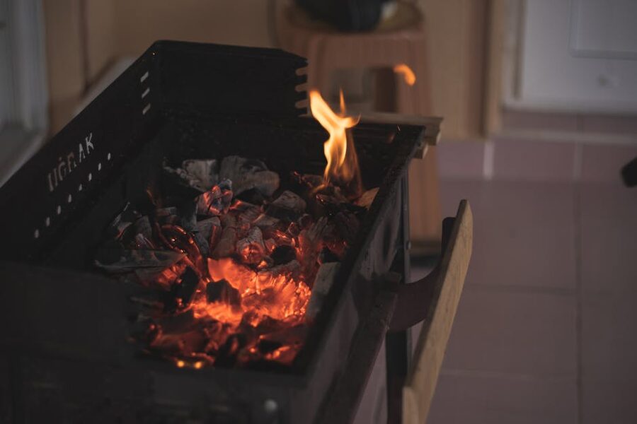 Hot charcoal inside a grill, glowing red, ready for cooking
