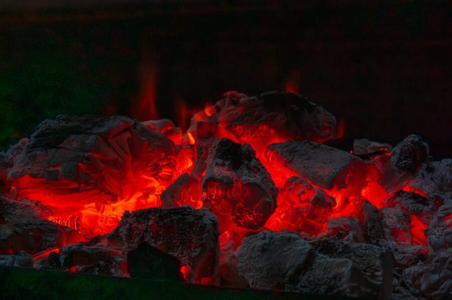 Glowing hot charcoal coals in a fire pit