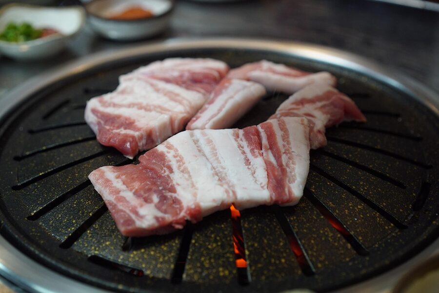 Grilled pork belly served at a restaurant table