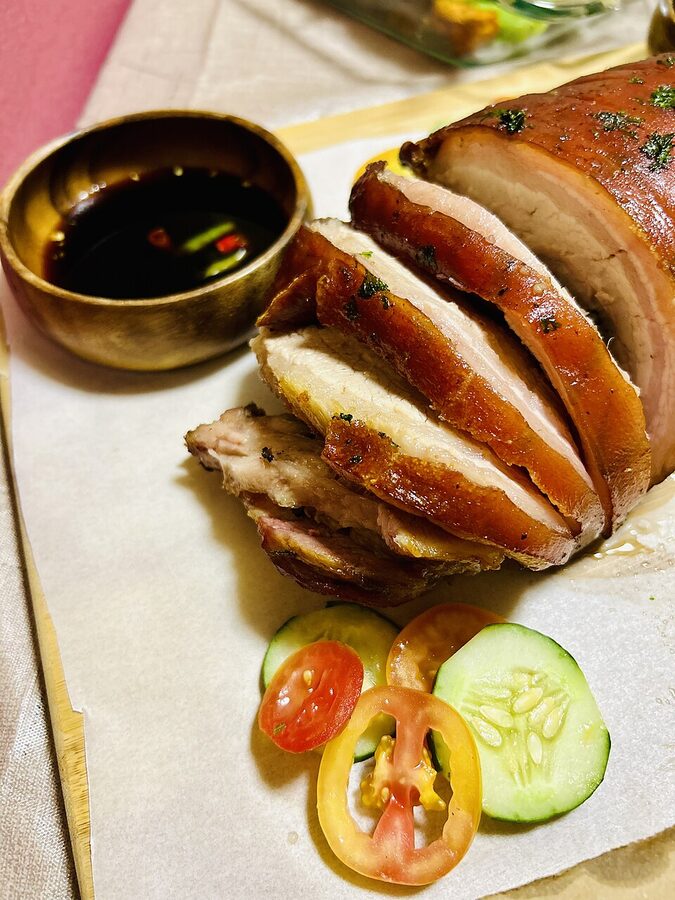 Close-up of Filipino pork lechon belly with crisp brown skin and visible meat layers