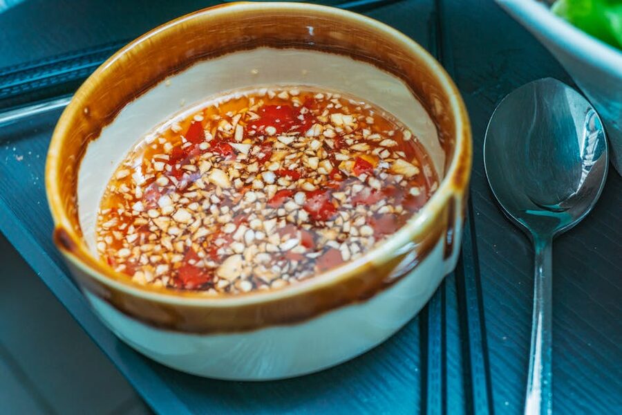 Vinegar dipping sauce with chopped garlic and chillies in a small bowl