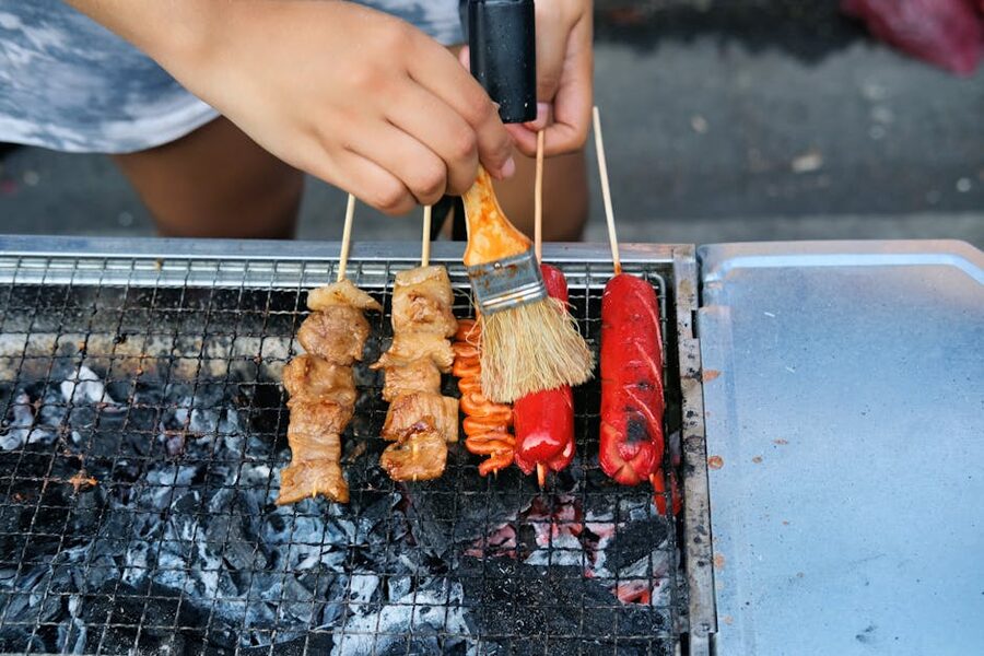 Filipino-style BBQ skewers grilling over charcoal