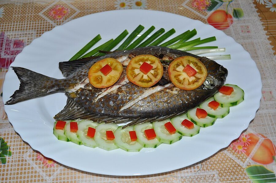 Whole grilled kitong fish on a plate, Cebu sutukil style